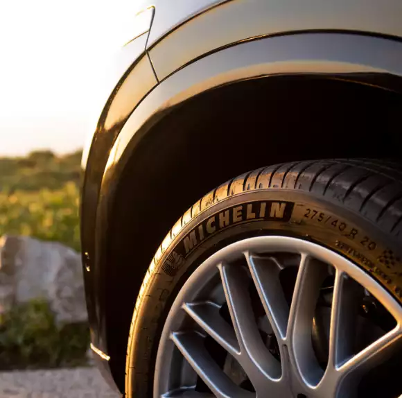 Close-up of a black car with Michelin wheels.
