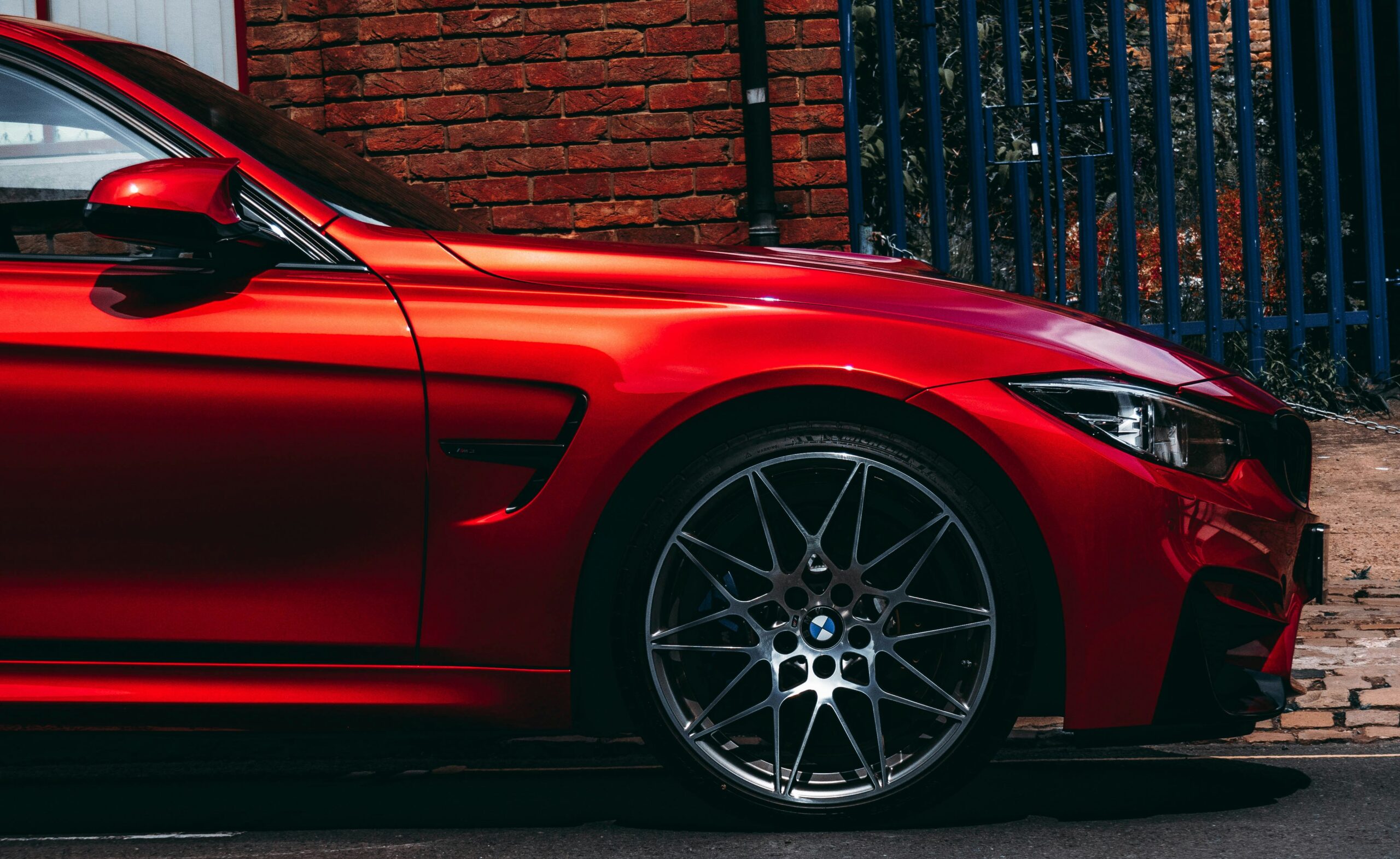 Bright red BMW with performance tyres